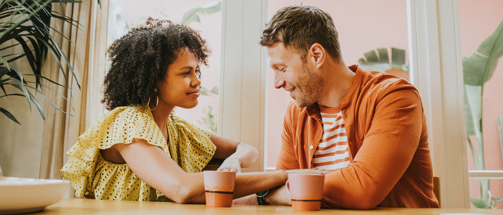 Man and woman look at each other and talk as a symbol for questions to ask